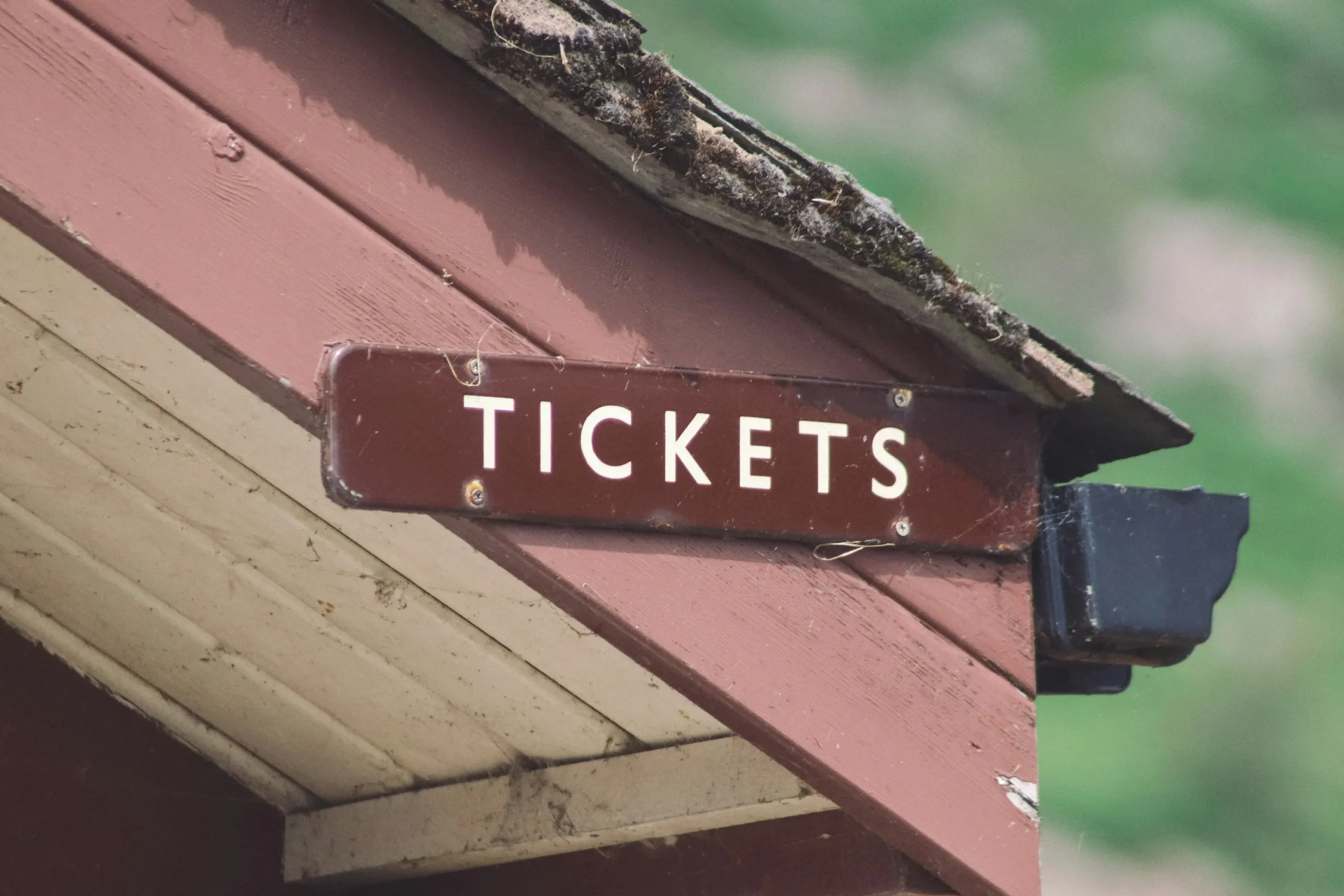 ticket sign on an old station roof