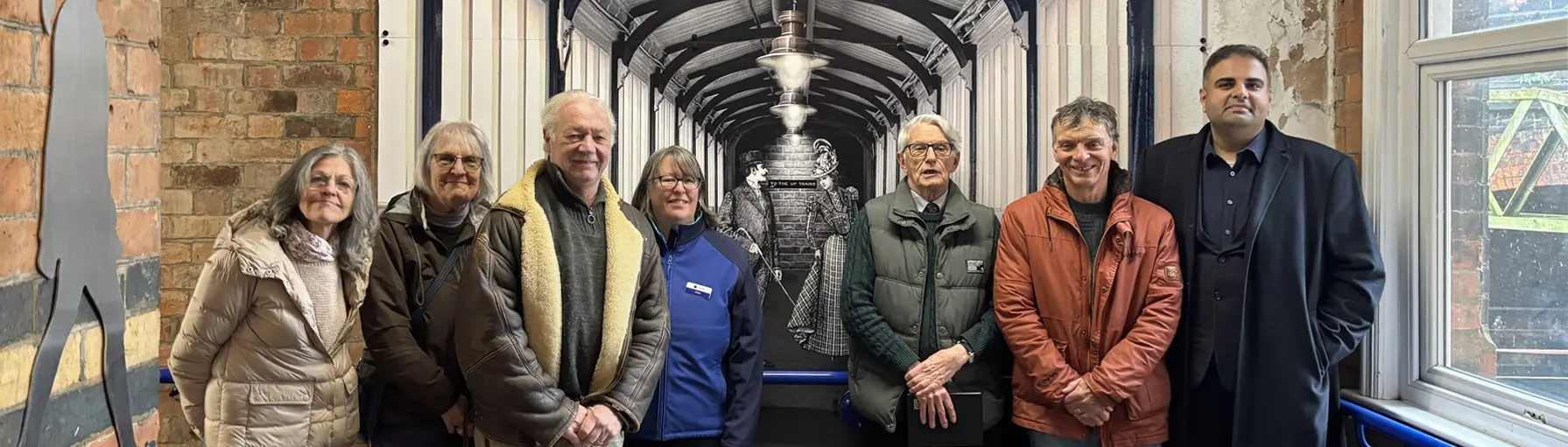 Group of people standing in front of an artwork