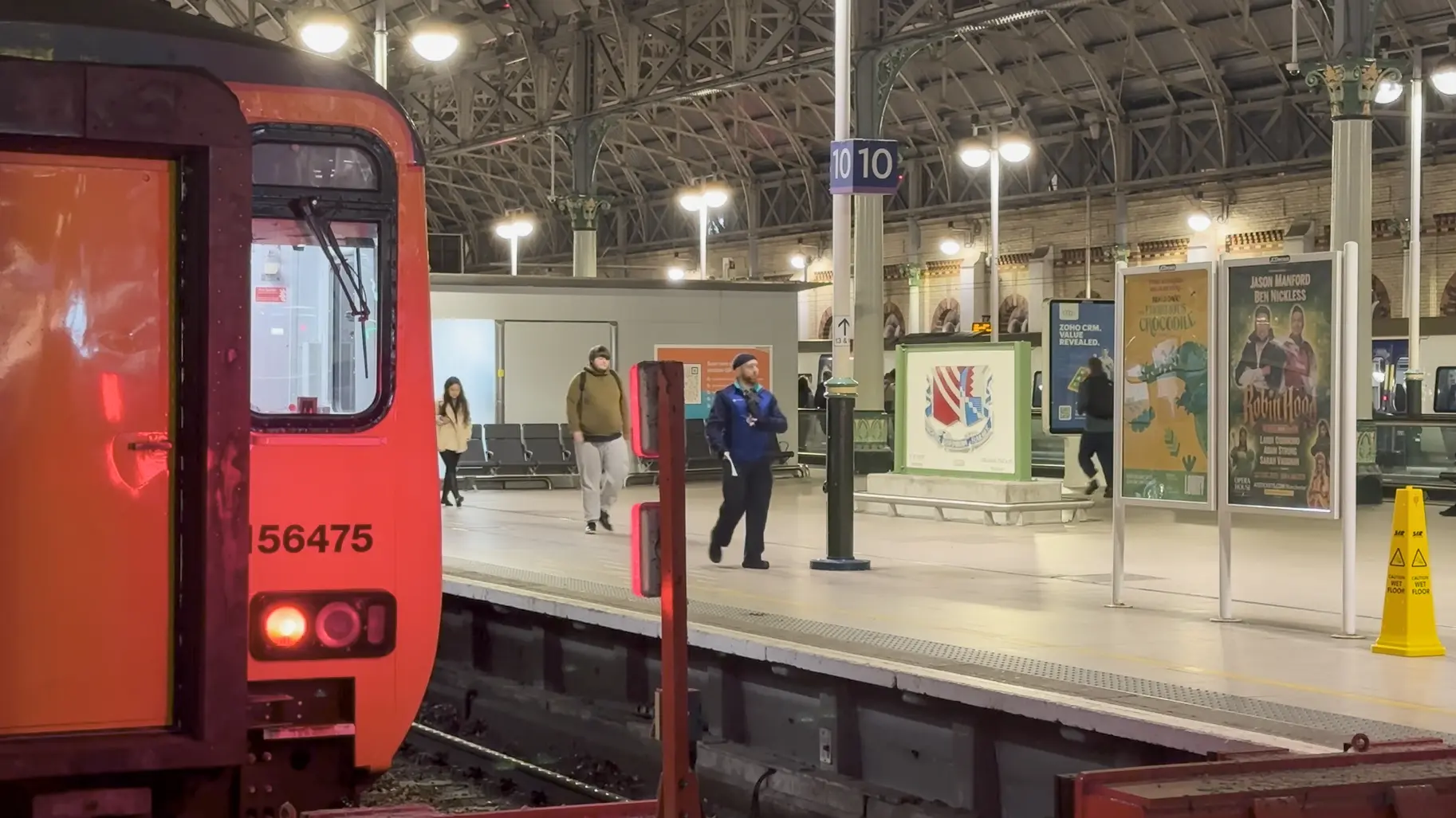 train at a station platform, with the plaque in the background