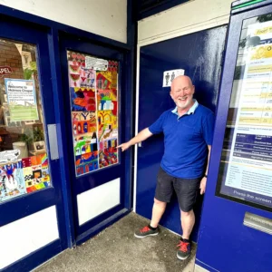 Holmes Chapel Station Master Graham Blake with some of the art created by local school children from Hermitage Primary School