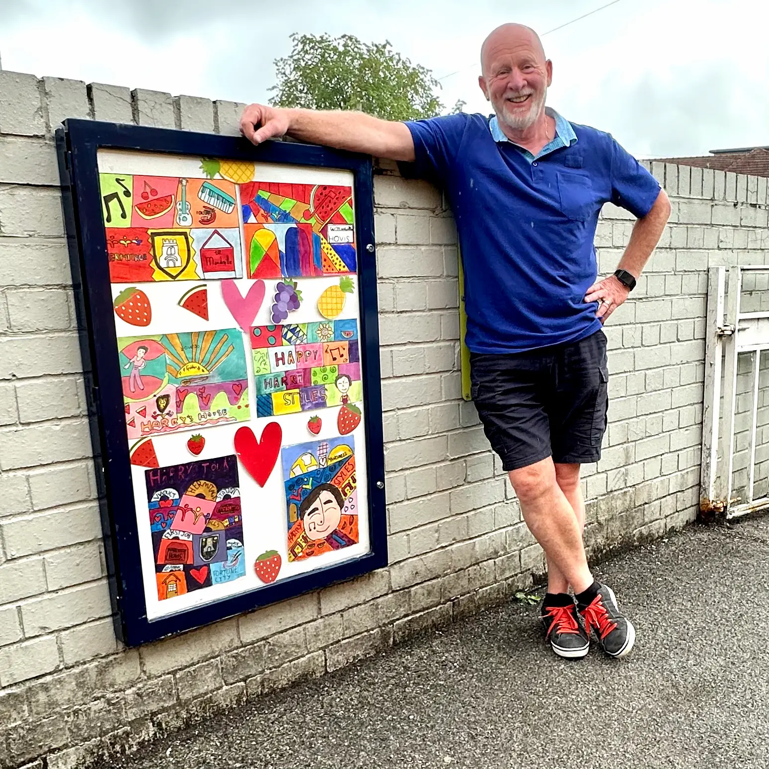 Holmes Chapel Station Master Graham Blake with some of the art created by local school children from Hermitage Primary School