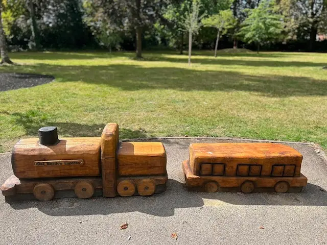 a wooden train in a park